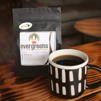 a cup of coffee sitting on top of a wooden table